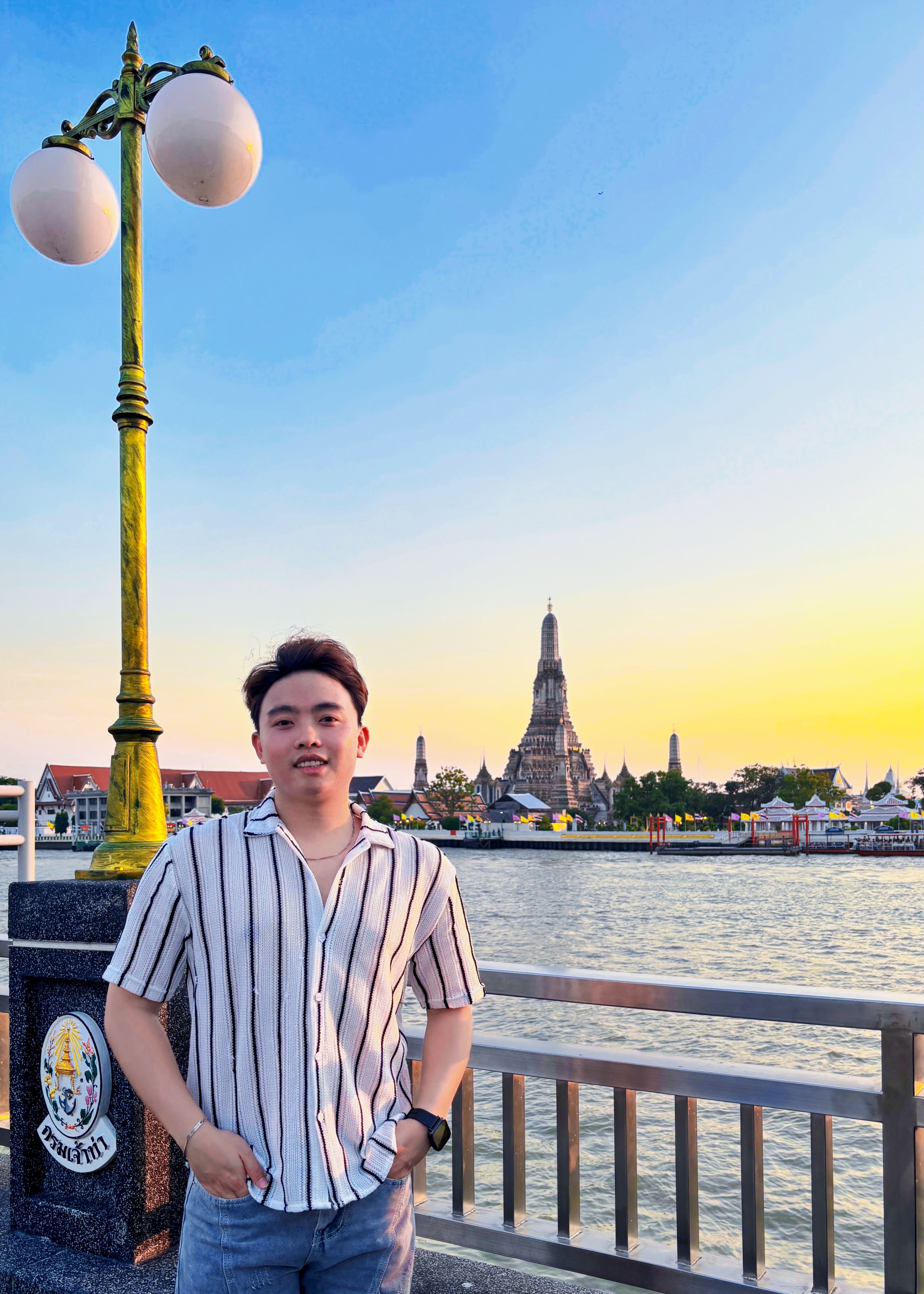 Nguyen Dang Hong Huy near a riverside landmark